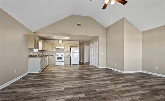 kitchen featuring dark wood finished floors, white appliances, a ceiling fan, visible vents, and under cabinet range hood