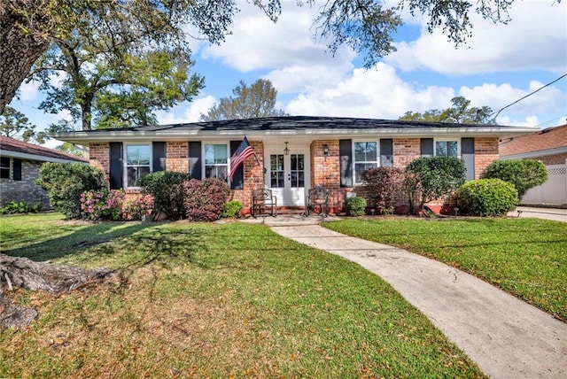 621 Gordon Ave, Harahan, LA 70123 - ranch-style house featuring brick siding, french doors, and a front lawn