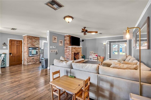 621 Gordon Ave, Harahan, LA 70123 - living room featuring hardwood / wood-style flooring, ceiling fan, visible vents, and a fireplace