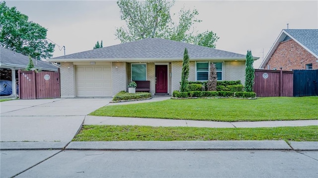 ranch-style home featuring an attached garage, fence, a front lawn, and concrete driveway