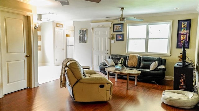 sitting room with crown molding, ceiling fan, wood finished floors, and baseboards