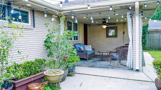 view of patio / terrace with ceiling fan and fence
