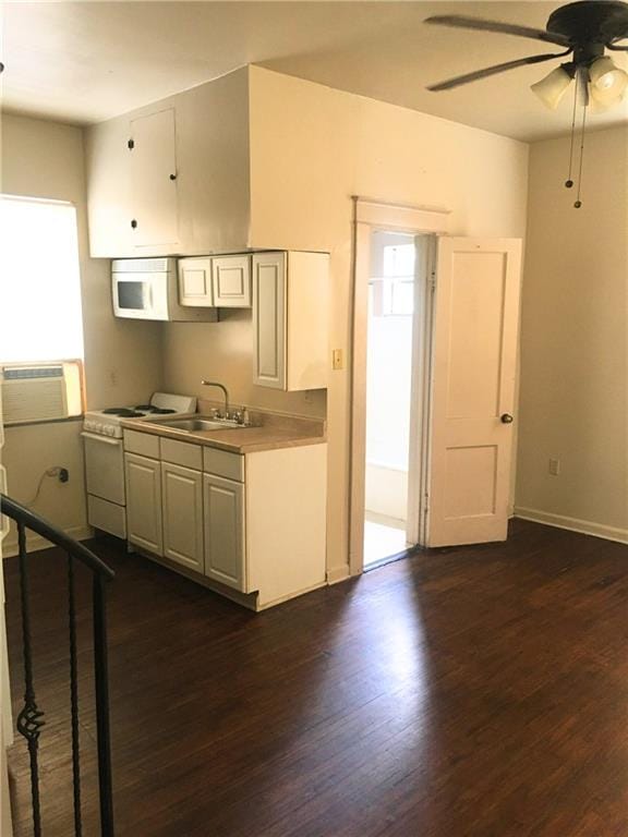212327 Carondelet St, New Orleans, LA 70130 - kitchen featuring white appliances, dark wood-style floors, light countertops, a ceiling fan, and a sink