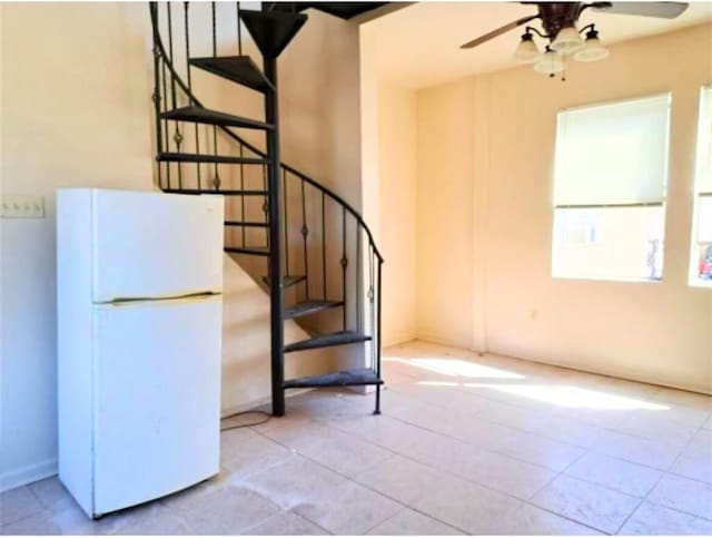 212327 Carondelet St, New Orleans, LA 70130 - stairs with ceiling fan and a healthy amount of sunlight