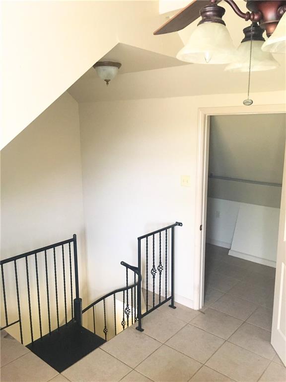 212327 Carondelet St, New Orleans, LA 70130 - interior space featuring light tile patterned floors and an upstairs landing