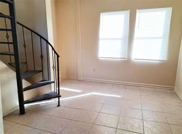 212327 Carondelet St, New Orleans, LA 70130 - staircase featuring baseboards and tile patterned flooring