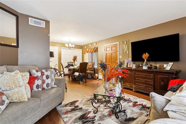 2205 Giuffrias Ave, Metairie, LA 70001 - living area with a notable chandelier, visible vents, and wood finished floors