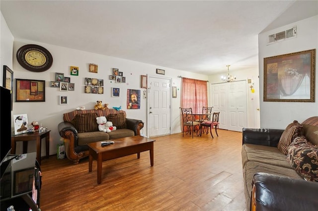 2205 Giuffrias Ave, Metairie, LA 70001 - living area with a chandelier, light wood finished floors, and visible vents