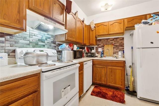 2205 Giuffrias Ave, Metairie, LA 70001 - kitchen with a sink, light countertops, white appliances, and under cabinet range hood