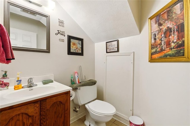 2205 Giuffrias Ave, Metairie, LA 70001 - bathroom featuring a textured ceiling, vanity, toilet, lofted ceiling, and tile patterned floors