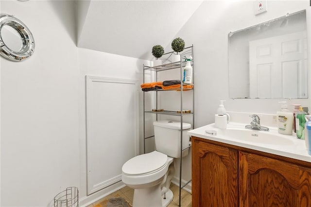 2205 Giuffrias Ave, Metairie, LA 70001 - half bath with tile patterned floors, toilet, vanity, and lofted ceiling