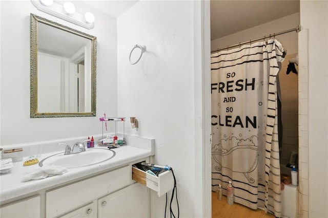 2205 Giuffrias Ave, Metairie, LA 70001 - bathroom with shower / bathtub combination with curtain, vanity, and wood finished floors