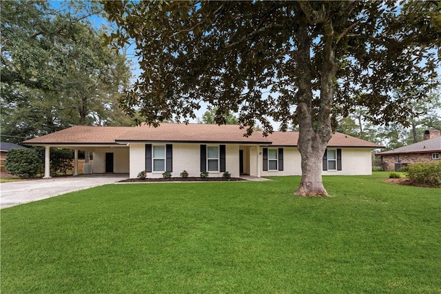 ranch-style house featuring brick siding, a front lawn, driveway, and a carport