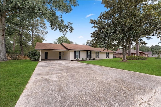 ranch-style house with a front lawn, fence, driveway, and a carport
