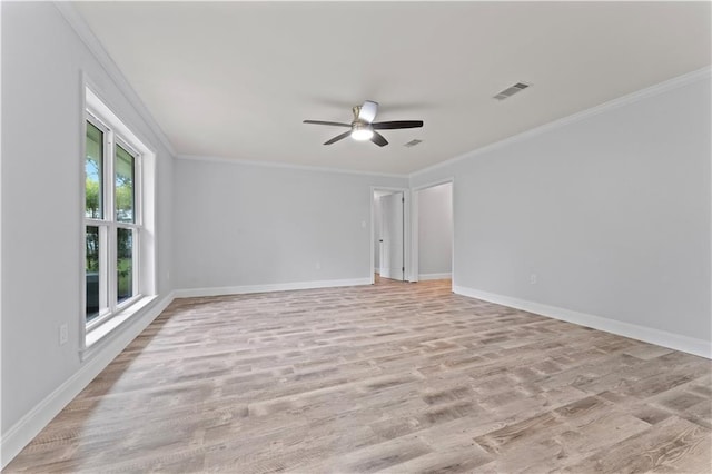 spare room with ceiling fan, visible vents, baseboards, and light wood-type flooring