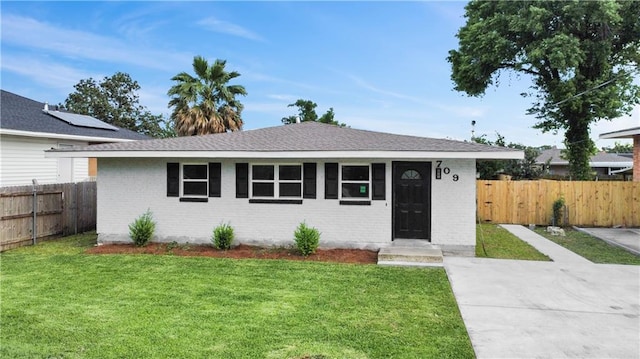 709 29th St, Kenner, LA 70062 - view of front facade with a front yard, brick siding, and fence