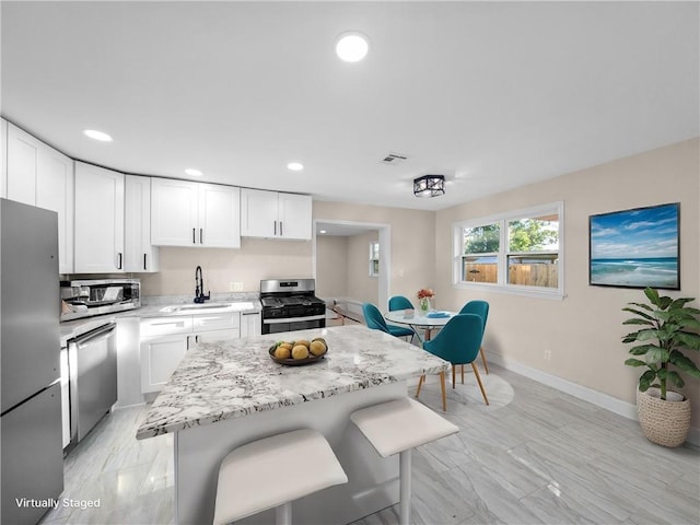 709 29th St, Kenner, LA 70062 - kitchen with a sink, visible vents, white cabinets, and stainless steel appliances
