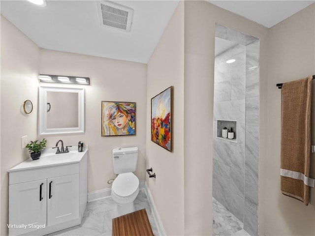 709 29th St, Kenner, LA 70062 - bathroom featuring tiled shower, visible vents, toilet, marble finish floor, and baseboards