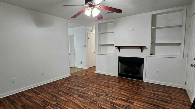 unfurnished living room with ceiling fan, a fireplace, visible vents, wood finished floors, and baseboards
