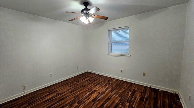 empty room with ceiling fan, baseboards, and dark wood-style floors