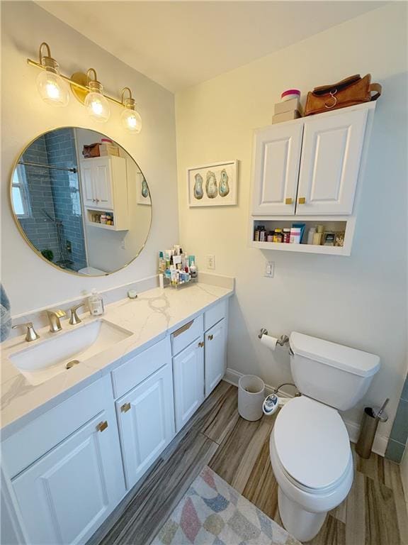 1101 Belmont Pl, Metairie, LA 70001 - bathroom with vanity, baseboards, wood finish floors, toilet, and a tile shower