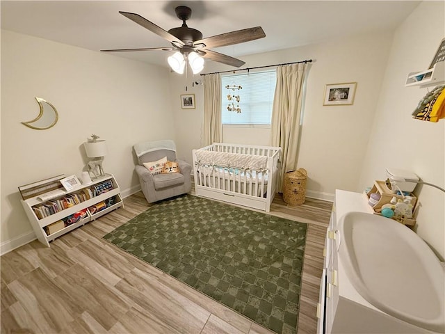 1101 Belmont Pl, Metairie, LA 70001 - bedroom featuring wood finished floors, baseboards, and a crib