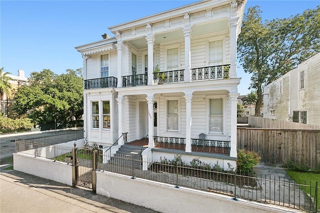 1631 Esplanade Ave Unit C, New Orleans, LA 70116 - view of front of property with a balcony, a porch, a fenced front yard, and a gate