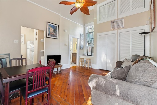 1631 Esplanade Ave Unit C, New Orleans, LA 70116 - living room featuring a ceiling fan, hardwood / wood-style flooring, a towering ceiling, and baseboards