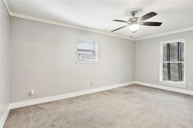 carpeted spare room featuring baseboards, ornamental molding, and ceiling fan