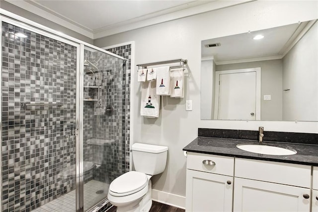 full bathroom featuring crown molding, vanity, a shower stall, and toilet