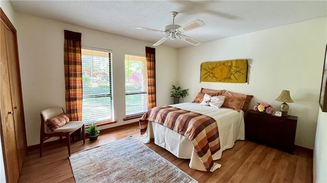 bedroom with baseboards, a ceiling fan, and wood finished floors