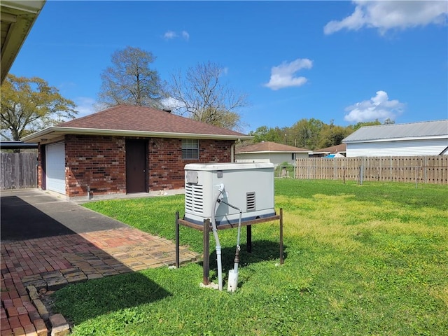 view of yard with fence and a garage