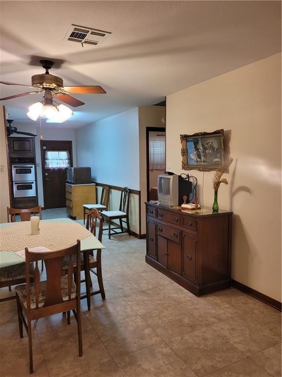 dining room with visible vents, ceiling fan, and baseboards