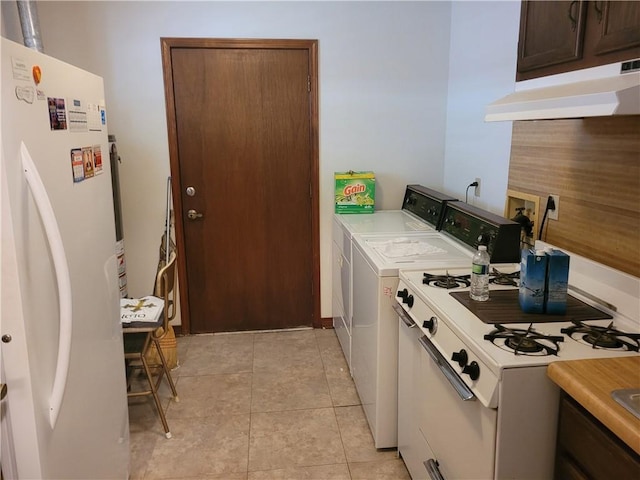 washroom featuring independent washer and dryer, light tile patterned floors, and laundry area