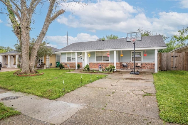 3403 W Loyola Dr, Kenner, LA 70065 - view of front of house featuring brick siding, covered porch, roof with shingles, and driveway