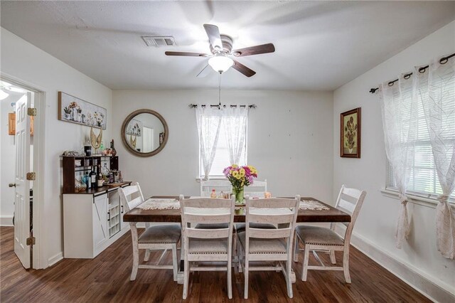 3403 W Loyola Dr, Kenner, LA 70065 - dining room with dark wood-type flooring, baseboards, a ceiling fan, and visible vents