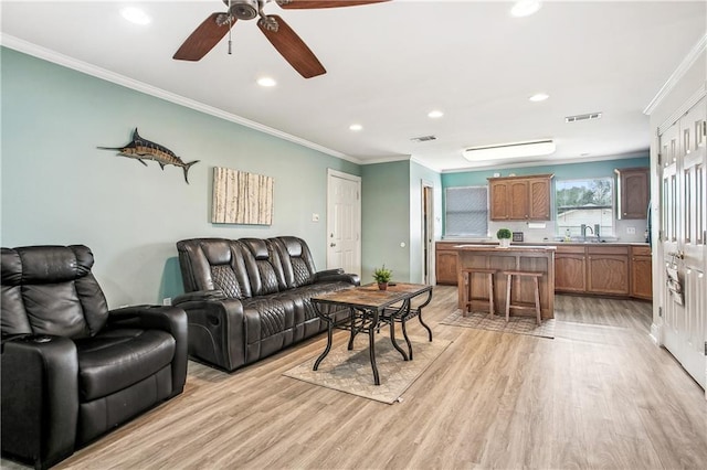 32875 Rivergate Cir Unit 28, Springfield, LA 70462 - living room featuring light wood-type flooring, ornamental molding, ceiling fan, and recessed lighting