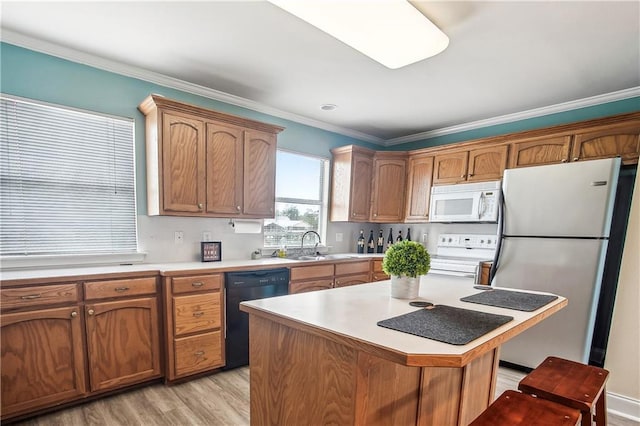 32875 Rivergate Cir Unit 28, Springfield, LA 70462 - kitchen featuring white appliances, a sink, light countertops, light wood-type flooring, and ornamental molding