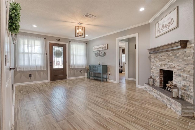 entrance foyer featuring a textured ceiling, visible vents, crown molding, light wood-type flooring, and a notable chandelier