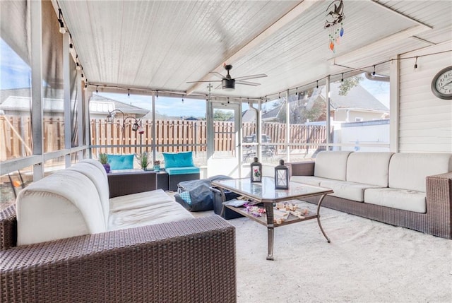 sunroom with an outdoor living space, ceiling fan, and a healthy amount of sunlight