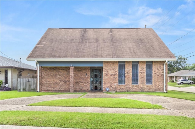 3952 Augusta St, Metairie, LA 70001 - view of front facade featuring brick siding, roof with shingles, and a front yard