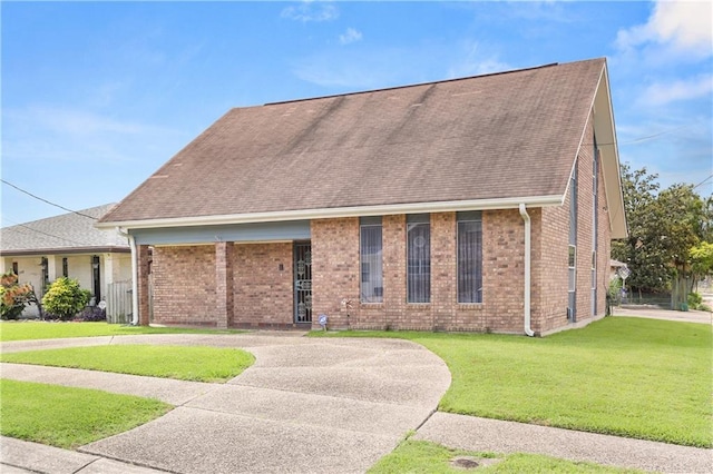 3952 Augusta St, Metairie, LA 70001 - view of front of house with brick siding, a shingled roof, and a front lawn