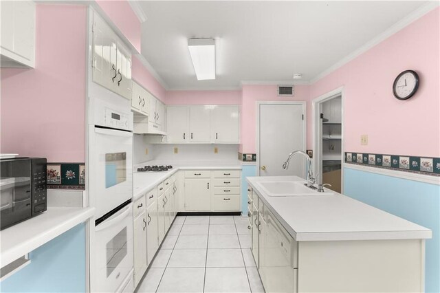 3952 Augusta St, Metairie, LA 70001 - kitchen with visible vents, crown molding, white appliances, light countertops, and a sink