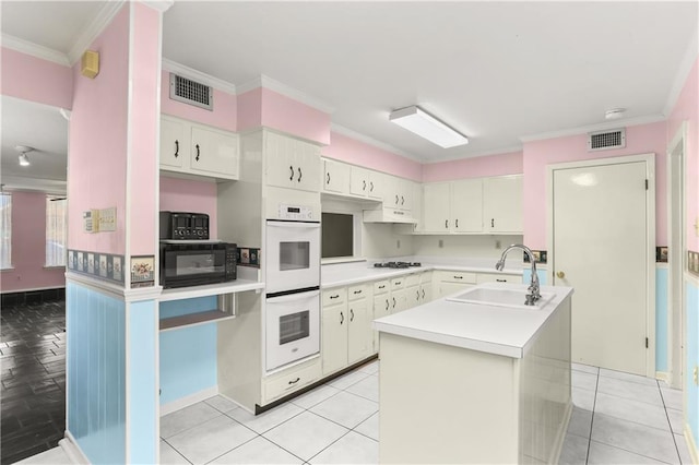 3952 Augusta St, Metairie, LA 70001 - kitchen featuring visible vents, black microwave, gas stovetop, a sink, and white double oven