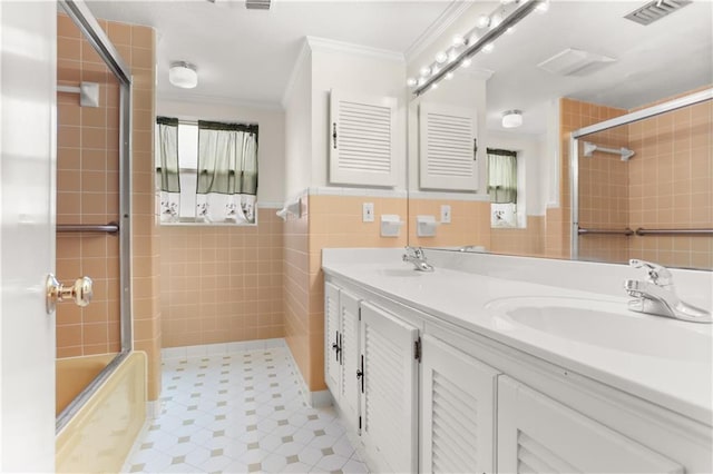 3952 Augusta St, Metairie, LA 70001 - bathroom featuring crown molding, a sink, visible vents, and tile walls