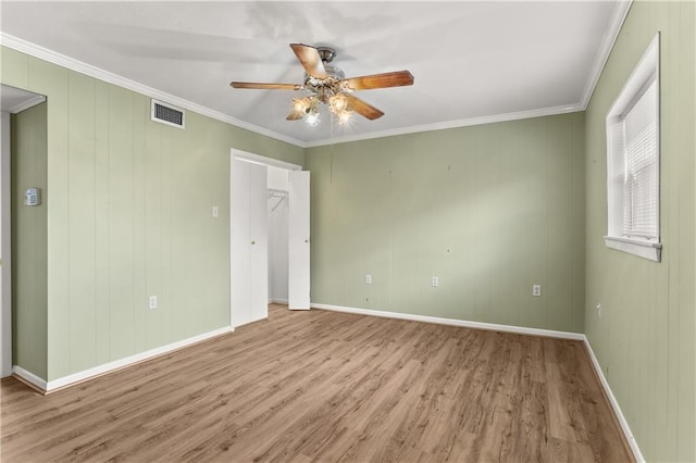 3952 Augusta St, Metairie, LA 70001 - spare room with crown molding, a ceiling fan, wood finished floors, and visible vents