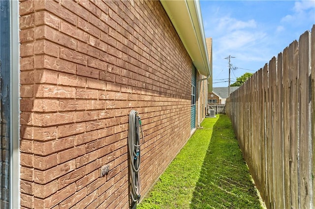 3952 Augusta St, Metairie, LA 70001 - view of home's exterior with brick siding, a lawn, and fence