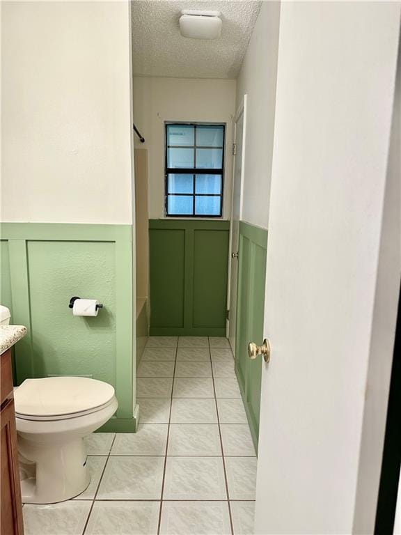 742 Central Ave, Reserve, LA 70084 - bathroom featuring toilet, a textured ceiling, vanity, wainscoting, and tile patterned flooring
