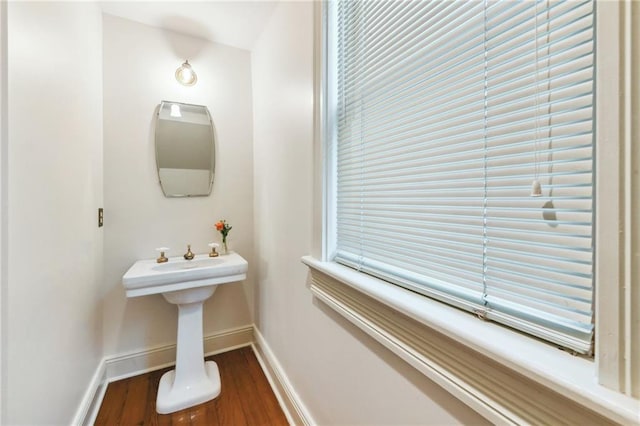 bathroom with baseboards and wood finished floors