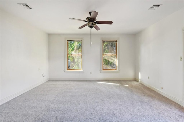 spare room featuring visible vents, ceiling fan, and carpet floors